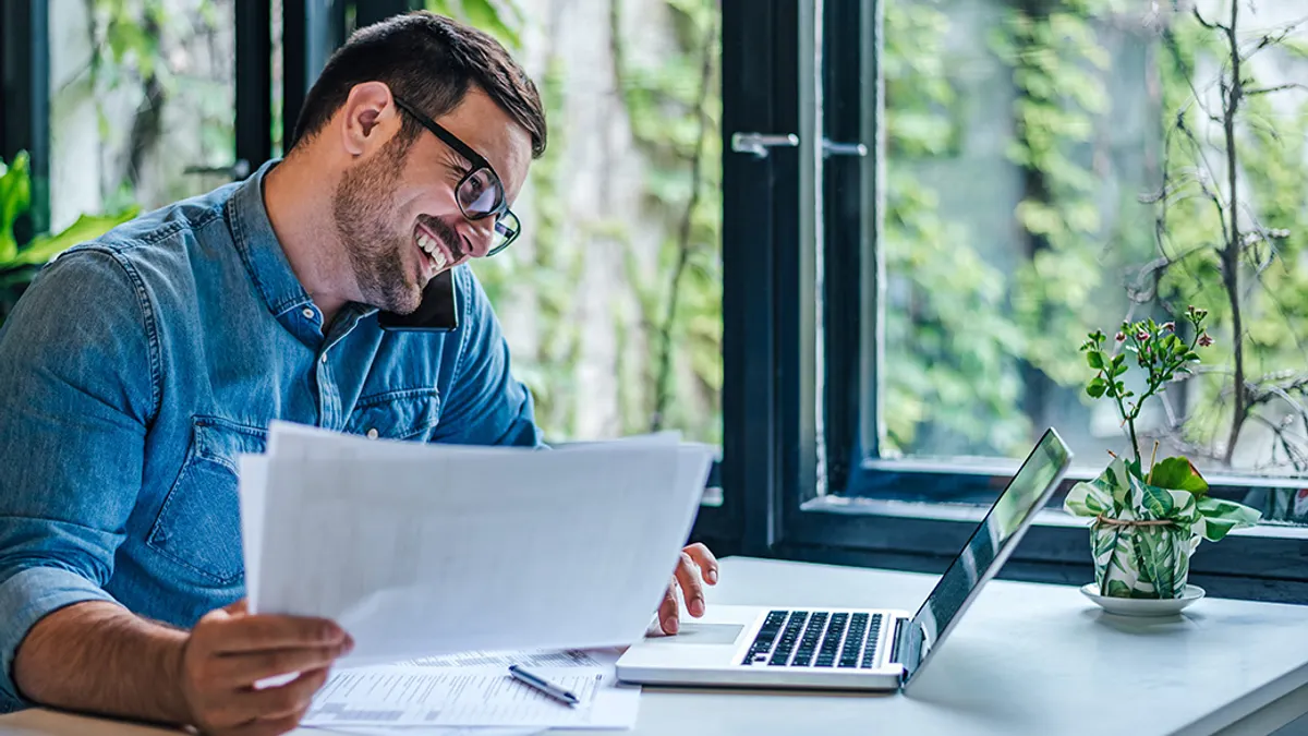 Man working at desk with laptop