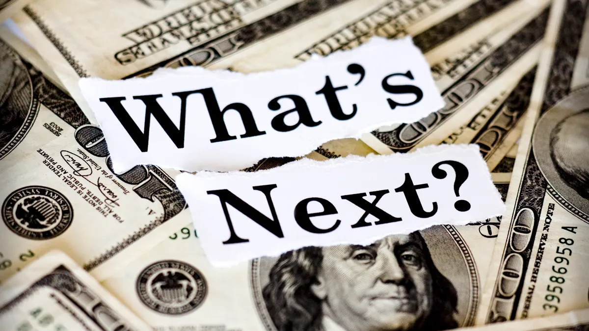 Uncertainty expressed by "What's Next" text superimposed on $100 bills