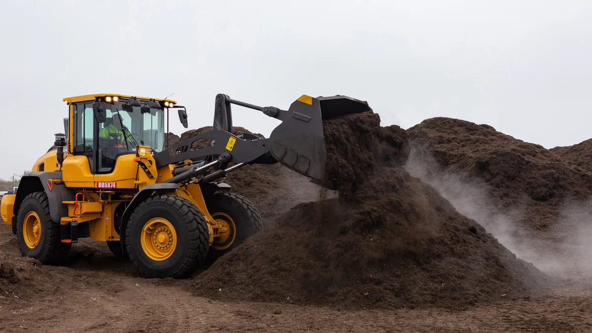 Agromin tractor moving compost in California