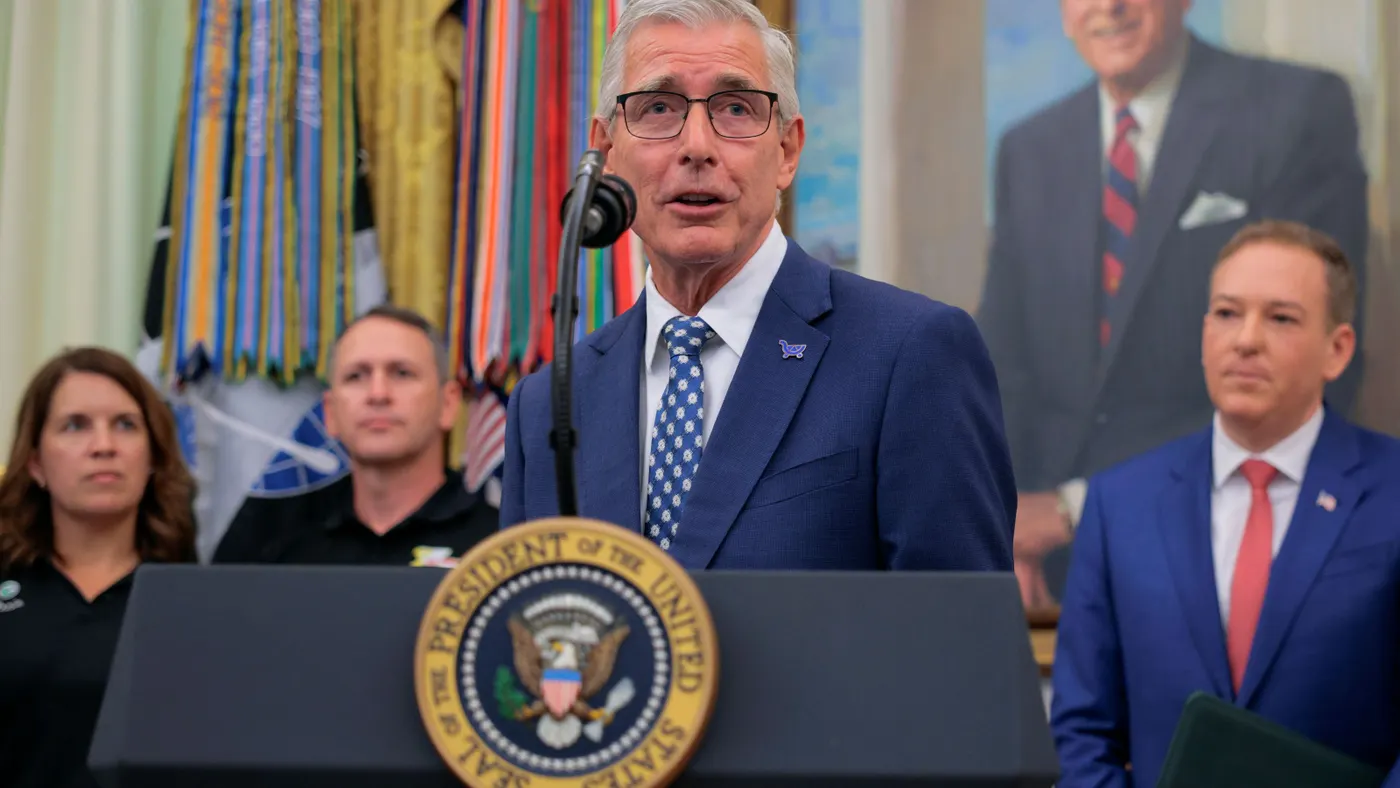 A person speaking at a podium.