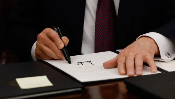 Closeup of president donald trump's signature on an executive order.