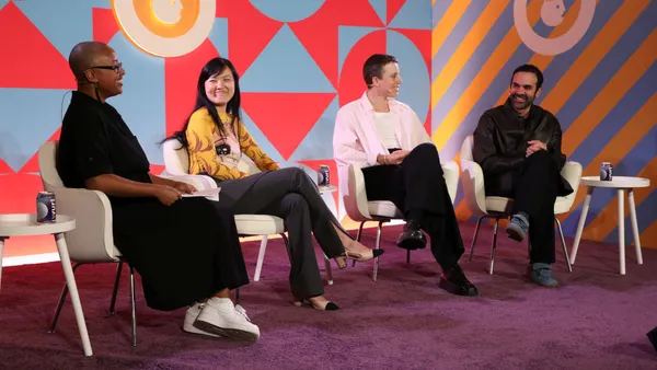 Four panelist sit on stage at New York City Advertising Week.