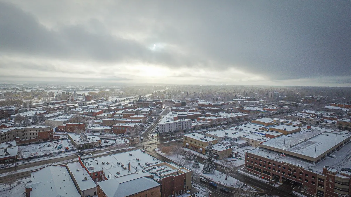 Aerial view of city of Fort Collins in winter with snow on top of buildings