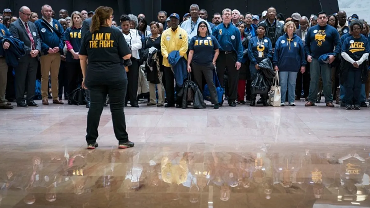 Members and supporters of the American Federation of Government Employees participate in a protest.