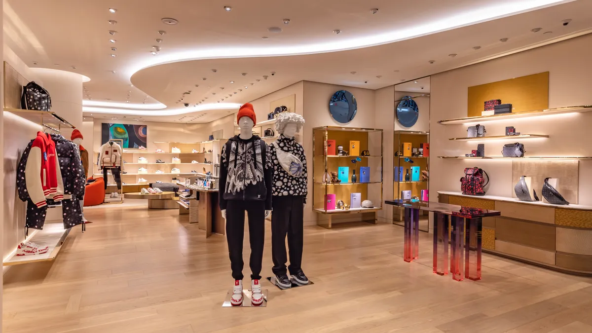 Two mannequins stand in the middle of the new Men's Seventh Floor at Saks Fifth Avenue New York.