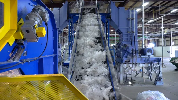 Conveyor belt with plastic film, within warehouse