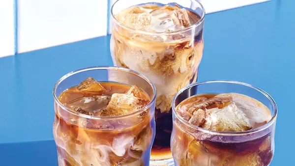 An image of three iced coffees with a sky blue background