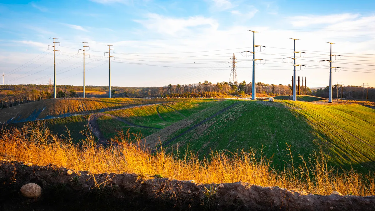 Transmission lines run across hills.