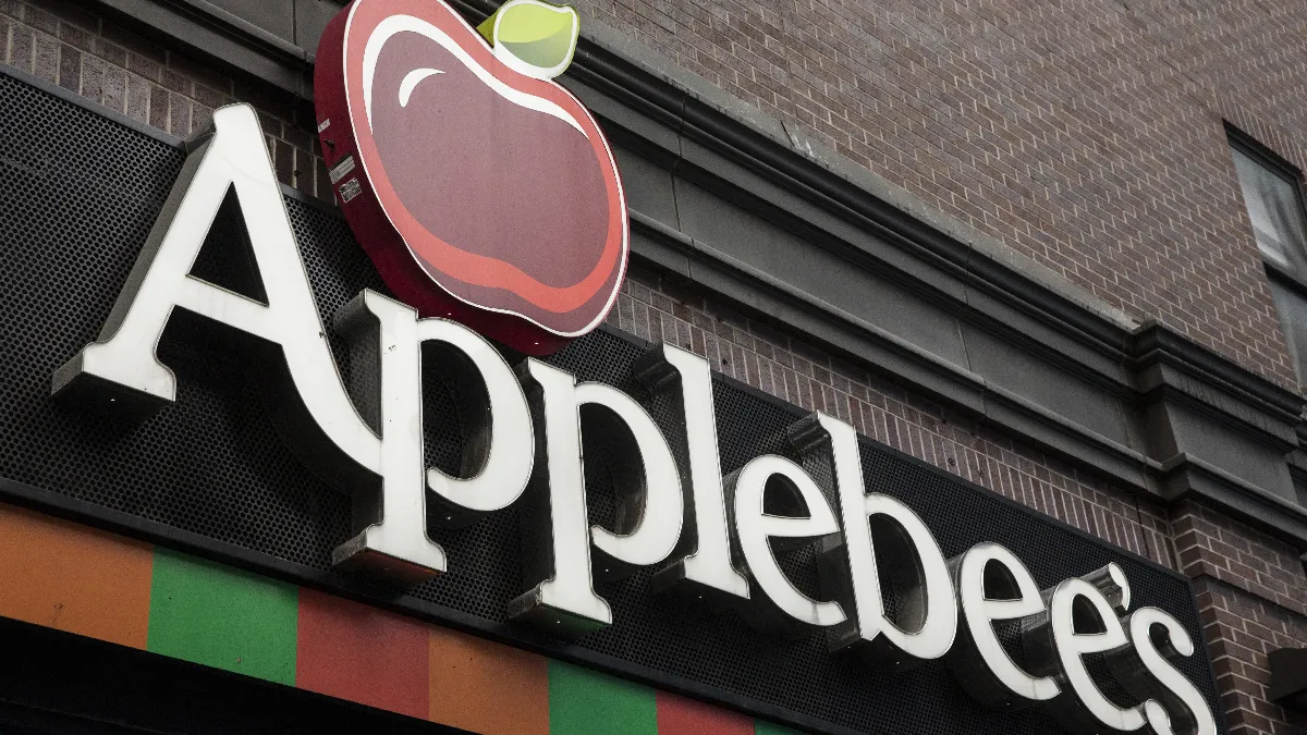 An image of a sign with a red apple and the word Applebee's