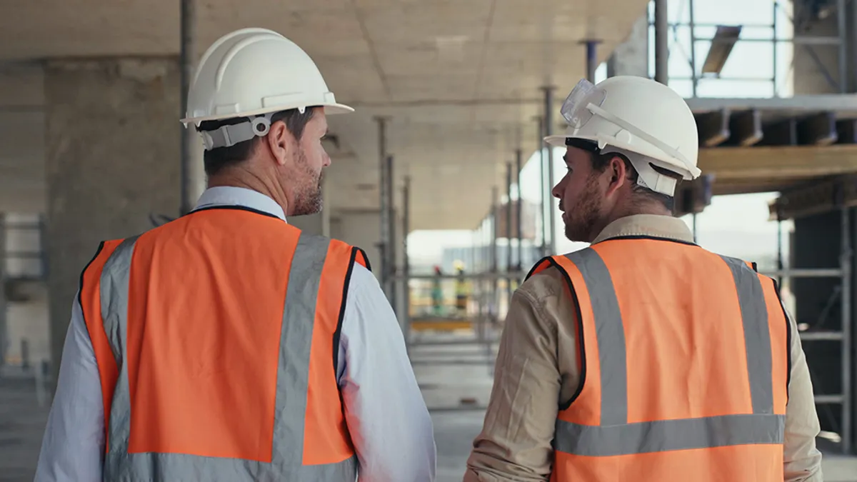 Construction contractors talking and walking ahead