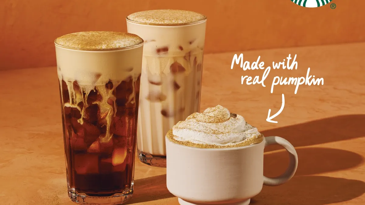 Three pumpkin themed coffee drinks from Starbucks. Two are iced, one is hot and has whipped cream.