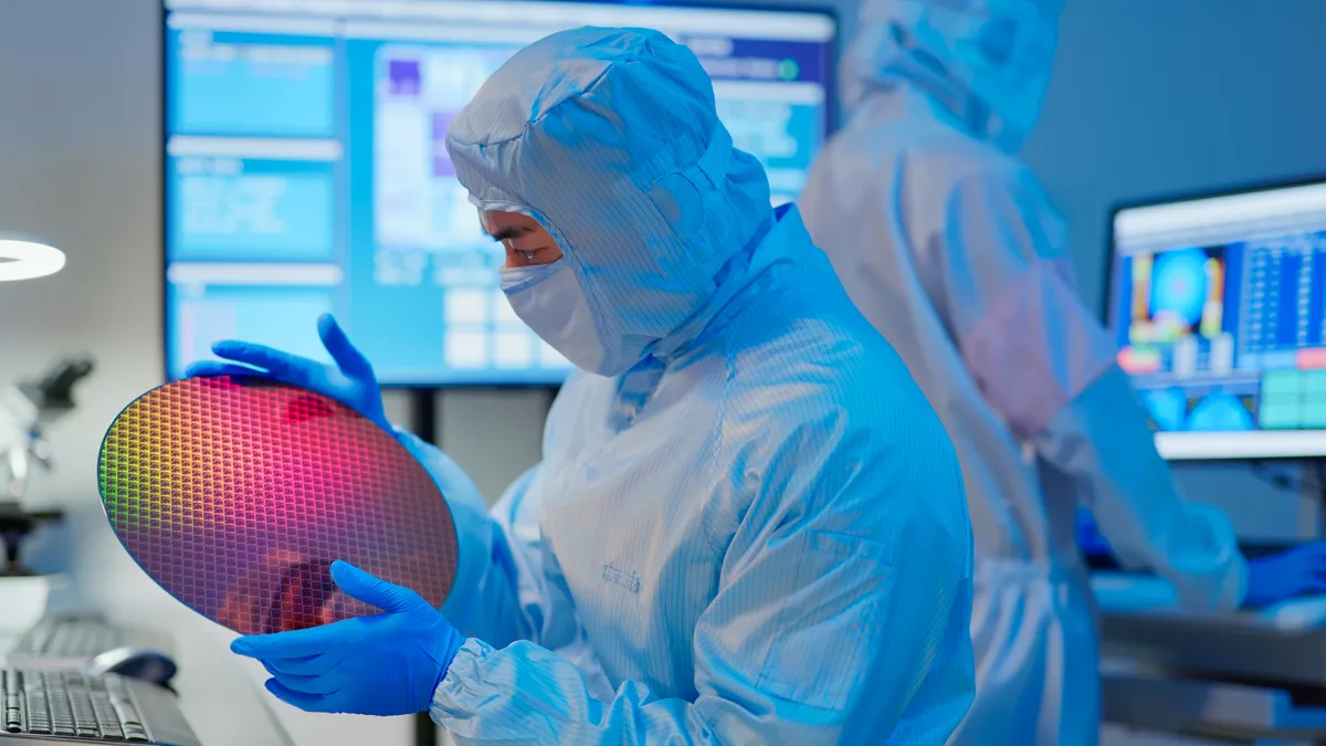 A technician wearing baby blue personal protective equipment