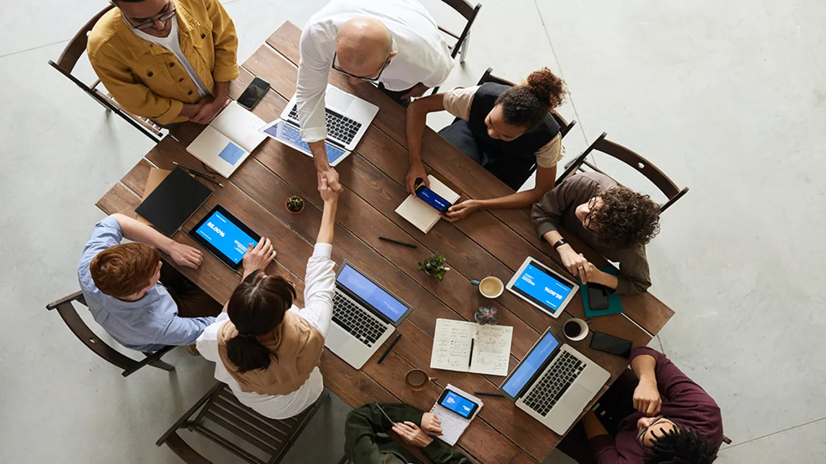 A group of employees having a meeting.