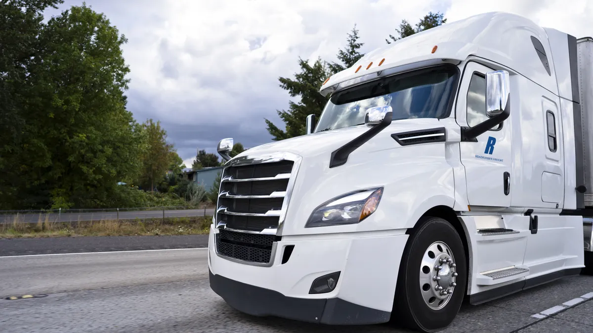 A white Roadrunner Transportation Systems truck