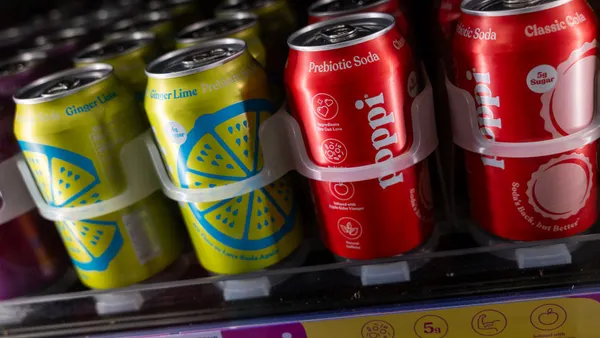 Cans of Poppi soda are displayed on a shelf