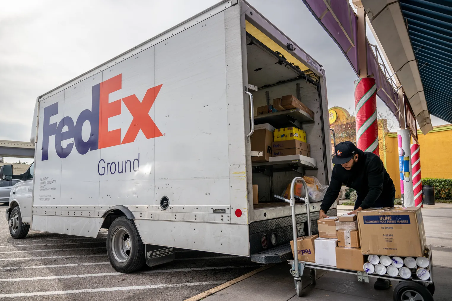 A worker organizes packages at a FedEx facility on December 21, 2022 in Houston, Texas.