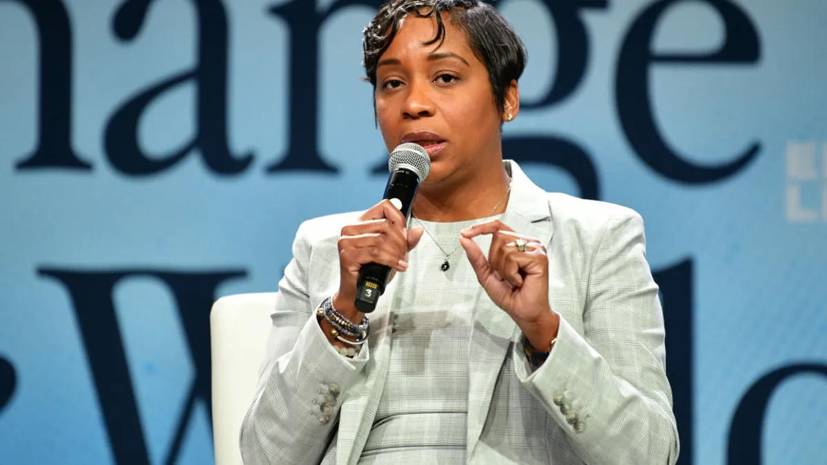 Andrea Joy Campbell speaking into a microphone