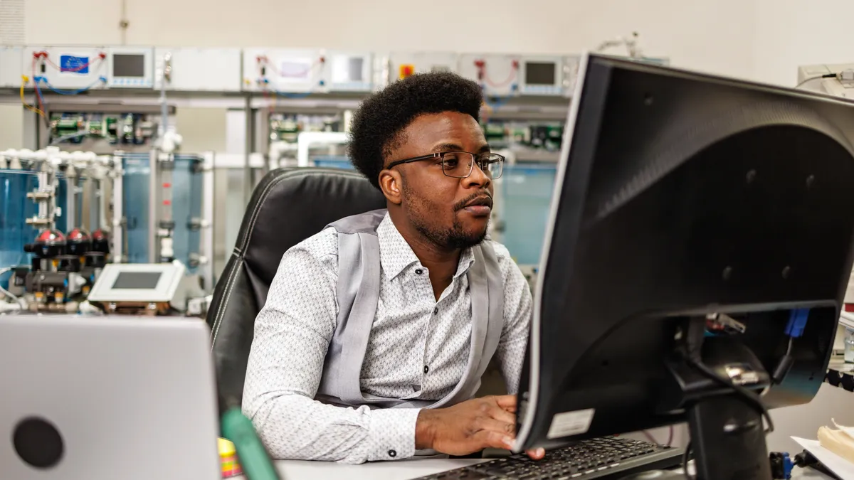 An individual works at a computer.