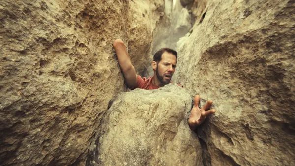 Mountaineer Aron Ralston recreates his harrowing real-life experience trapped between a boulder in an ad for Columbia Sportswear.