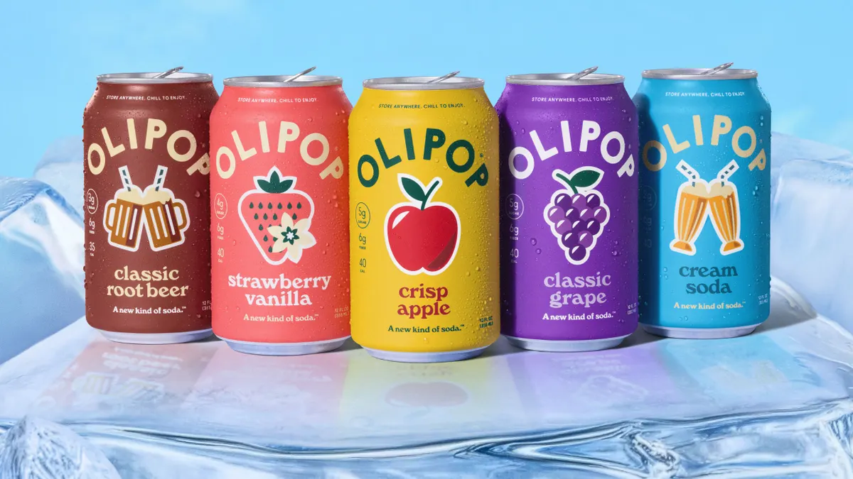Cans of Olipop are on display side by side against a light blue background.