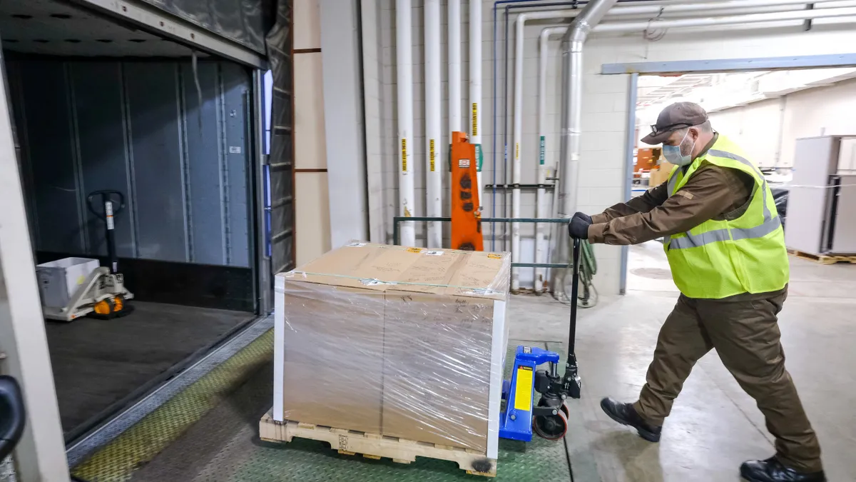 UPS driver Kerry Vannada loads the first VOCSN critical care ventilators for shipping Thursday, April 16, 2020, from the General Motors manufacturing facility in Kokomo, Indiana