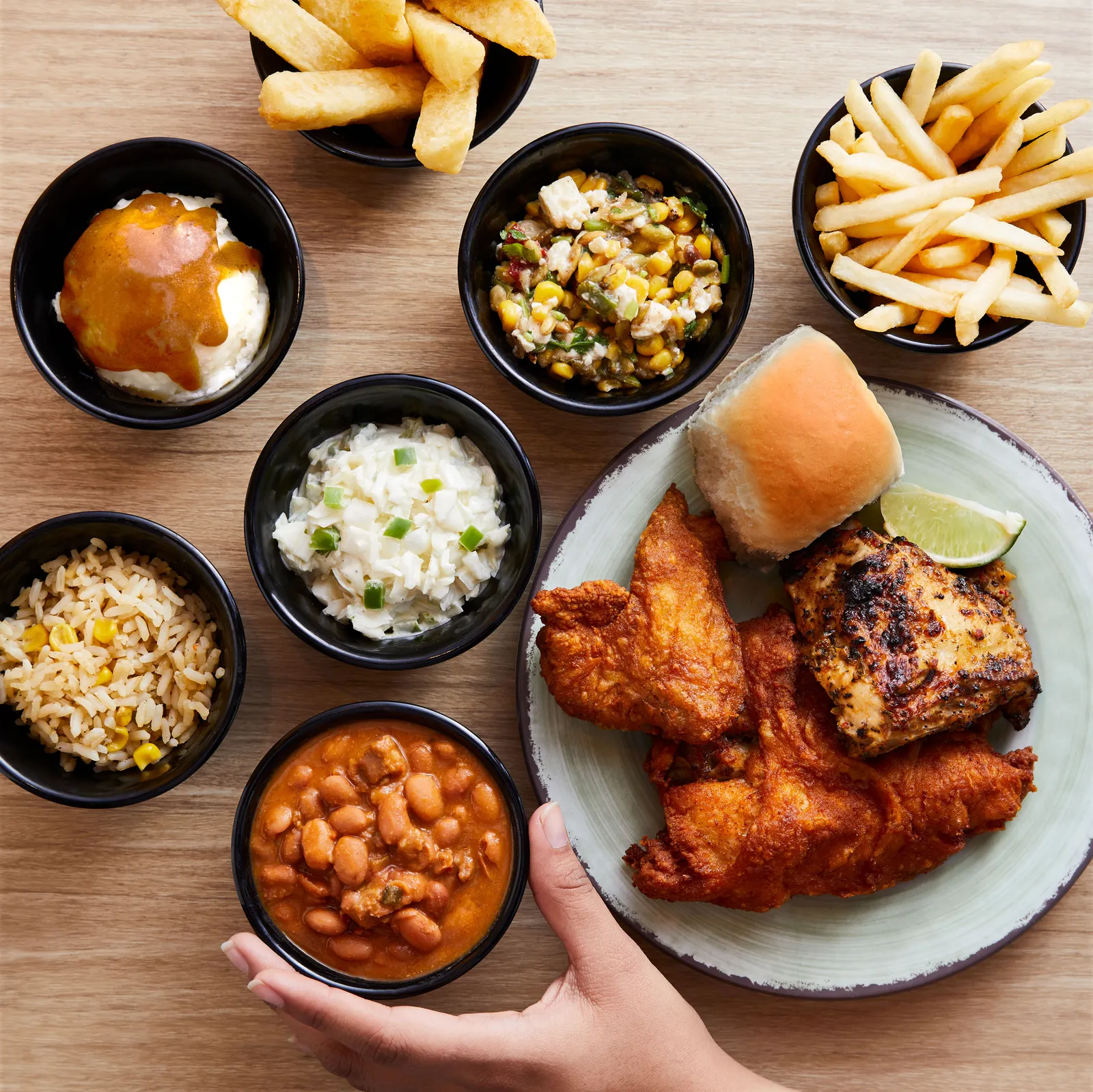 A plate of chicken, a role and various sides from Pollo Campero