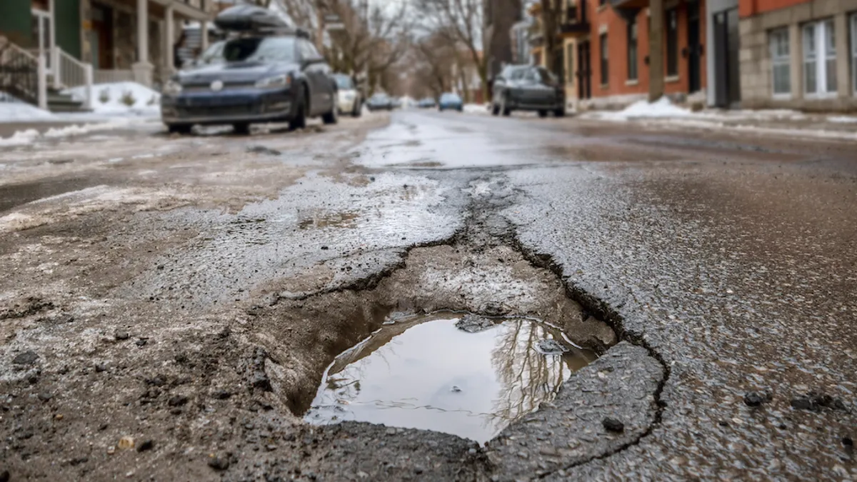 Large deep pothole in Montreal street, Canada