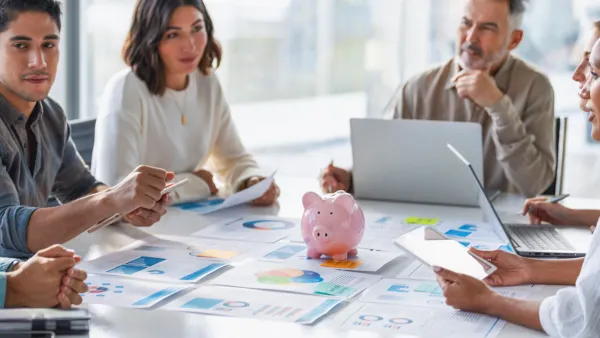 business people with a piggy bank