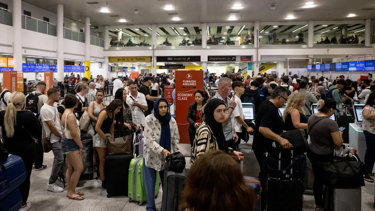 Passengers crowd an airport due to delays and cacelations