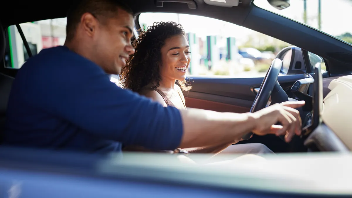 Couple in car at dealership