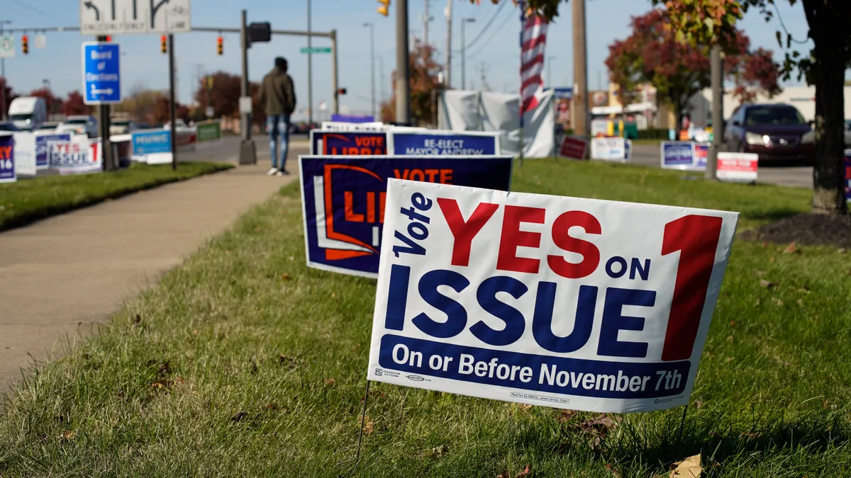 Voting signs laid out across the grass.