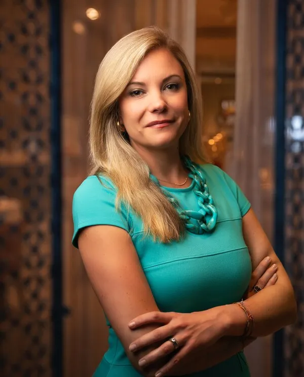 Cracker Barrel CMO Sarah Moore wearing a turquoise dress and matching necklace