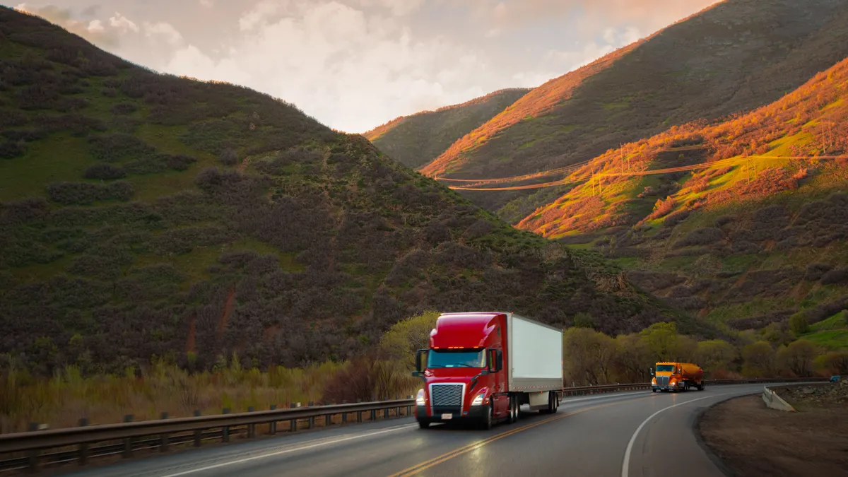 Red and white semi-truck driving