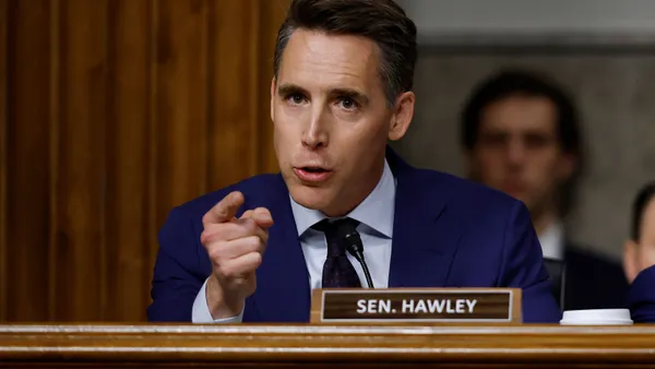 Senator Josh Hawley points his figure toward the during questioning from a perch on the chamber's raised platform.