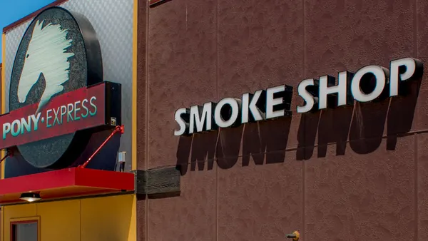 A photo of the exterior of a building. Signs say Pony Express and Smoke Shop.