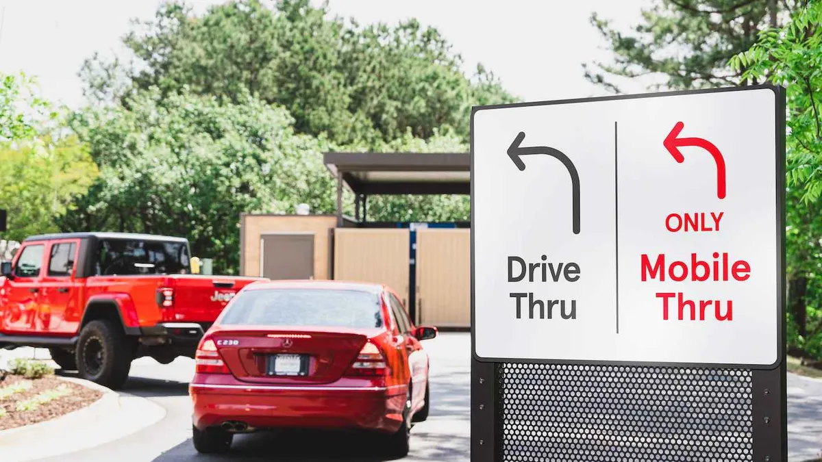 An image of two cars waiting at Chick-fil-A's drive-thru