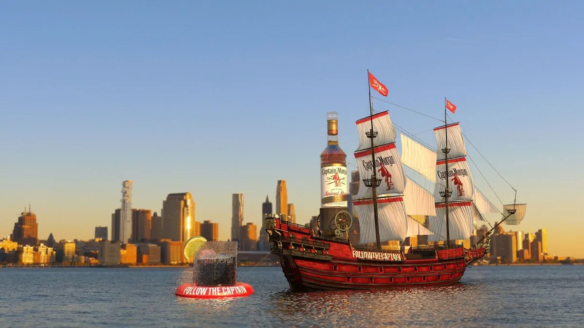 A red Captain Morgan Boat pulls a glass behind it.