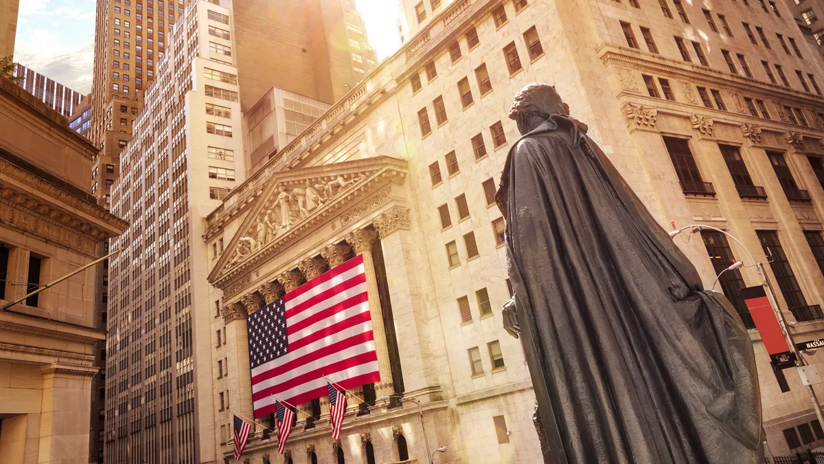 Famous Wall street and the building in New York, New York Stock Exchange with patriot flag