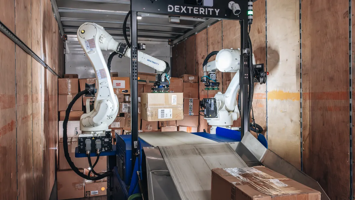 Dexterity AI's robot, DexR, loads boxes inside a trailer.