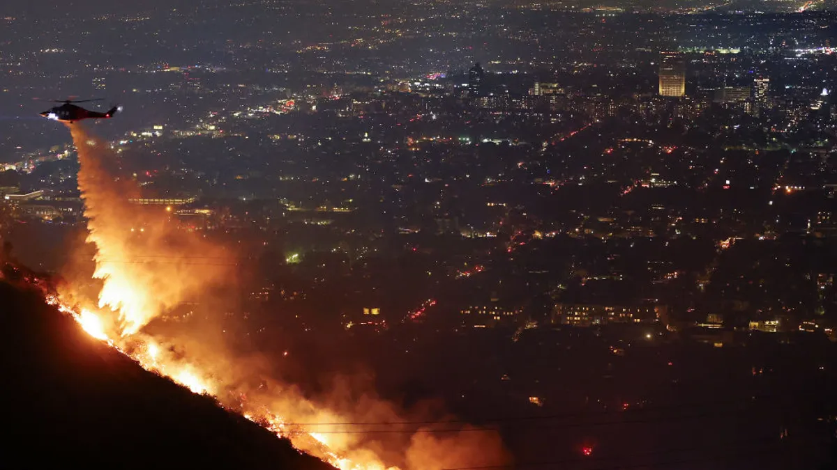 A helicopter sprays wildfires.