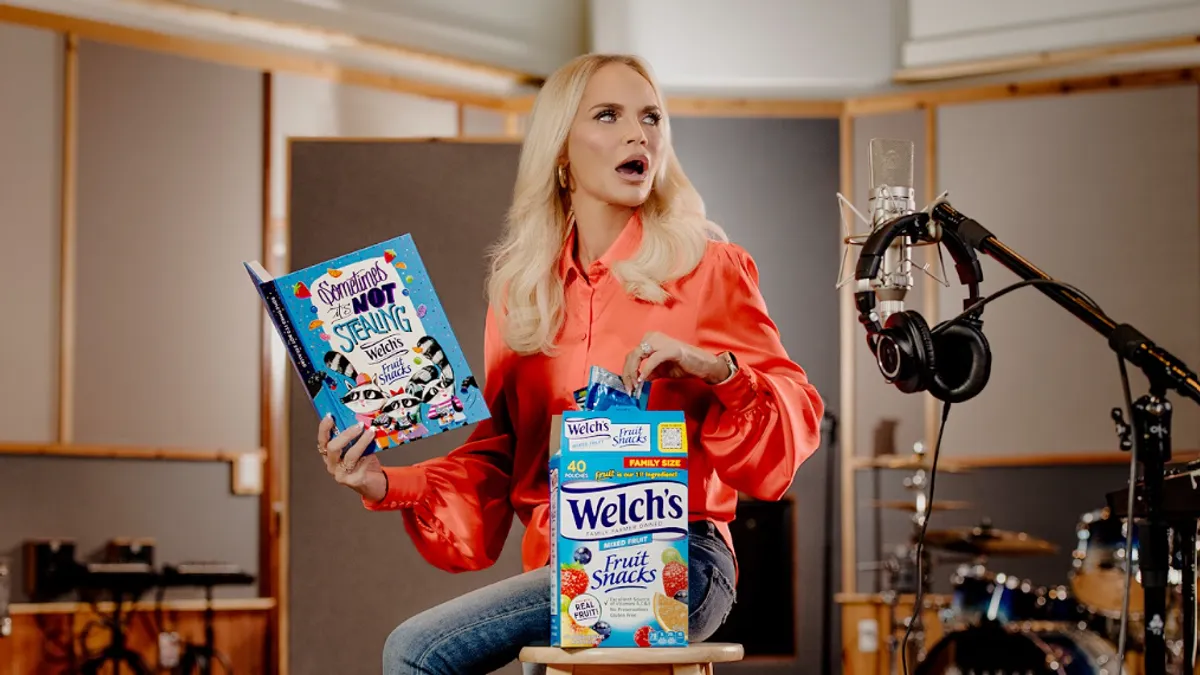 Actor Kristin Chenoweth is seen sitting in a sound studio narrating Welch's Fruit Snacks' first-ever storybook, "Sometimes It's Not Stealing," while holding a box of fruit snacks.