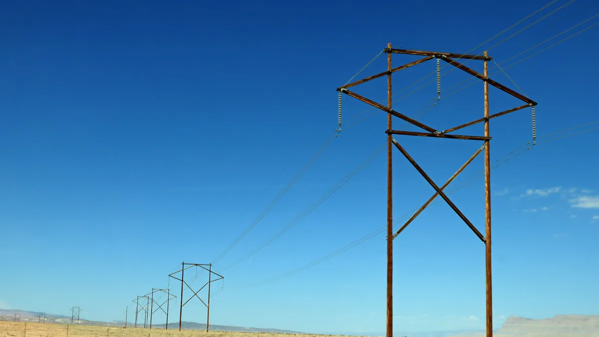 Electric power lines cross a desert.