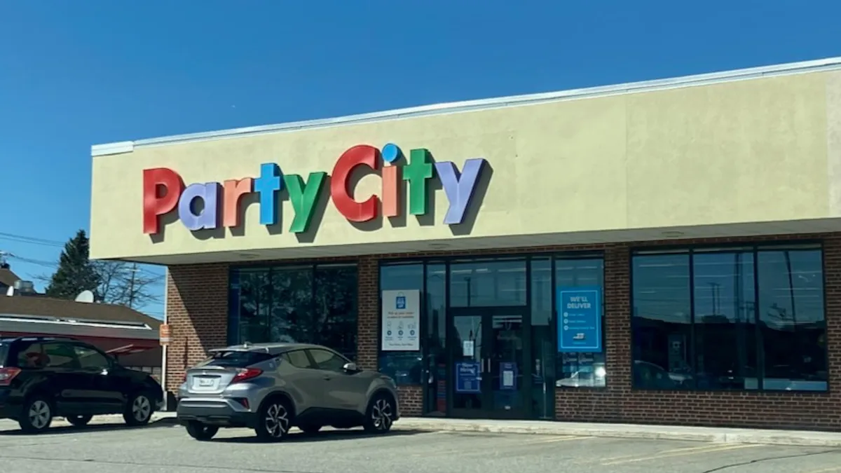 Cars parked in front of a retail strip center.