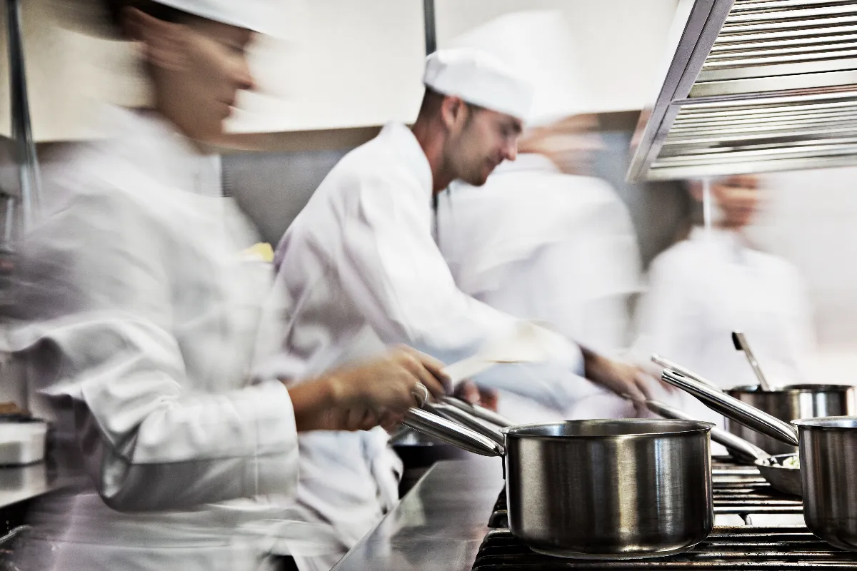 A photograph of chefs in a kitchen.