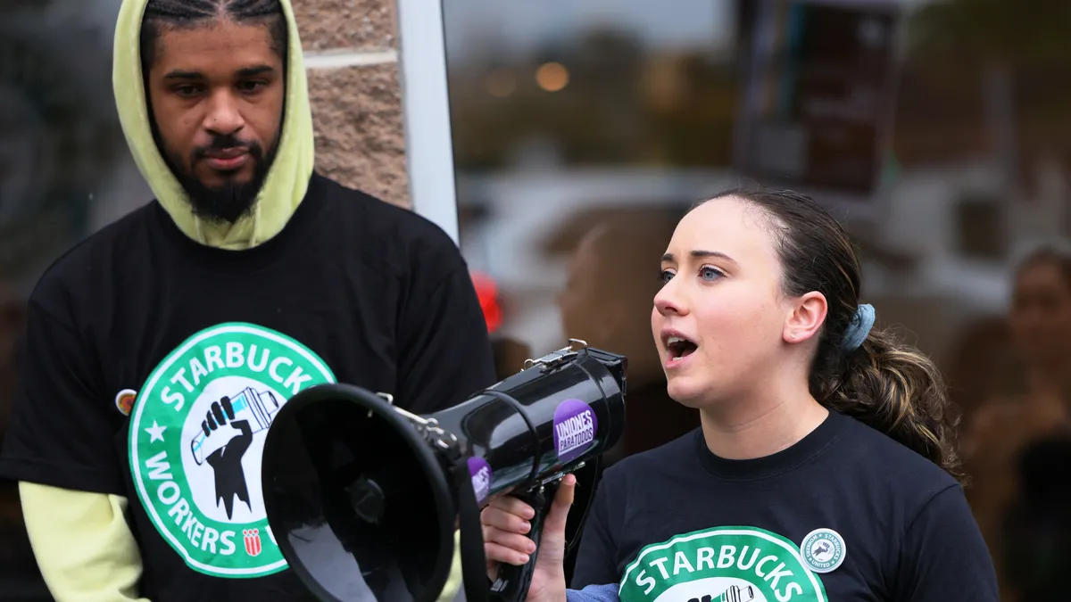 A Starbucks union member speaks into a megaphone