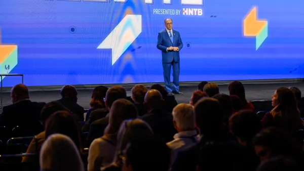 A person on stage viewed from the audience.