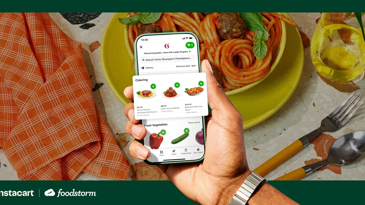 Photo illustration of a hand holding a phone showing a food catering section in an app.