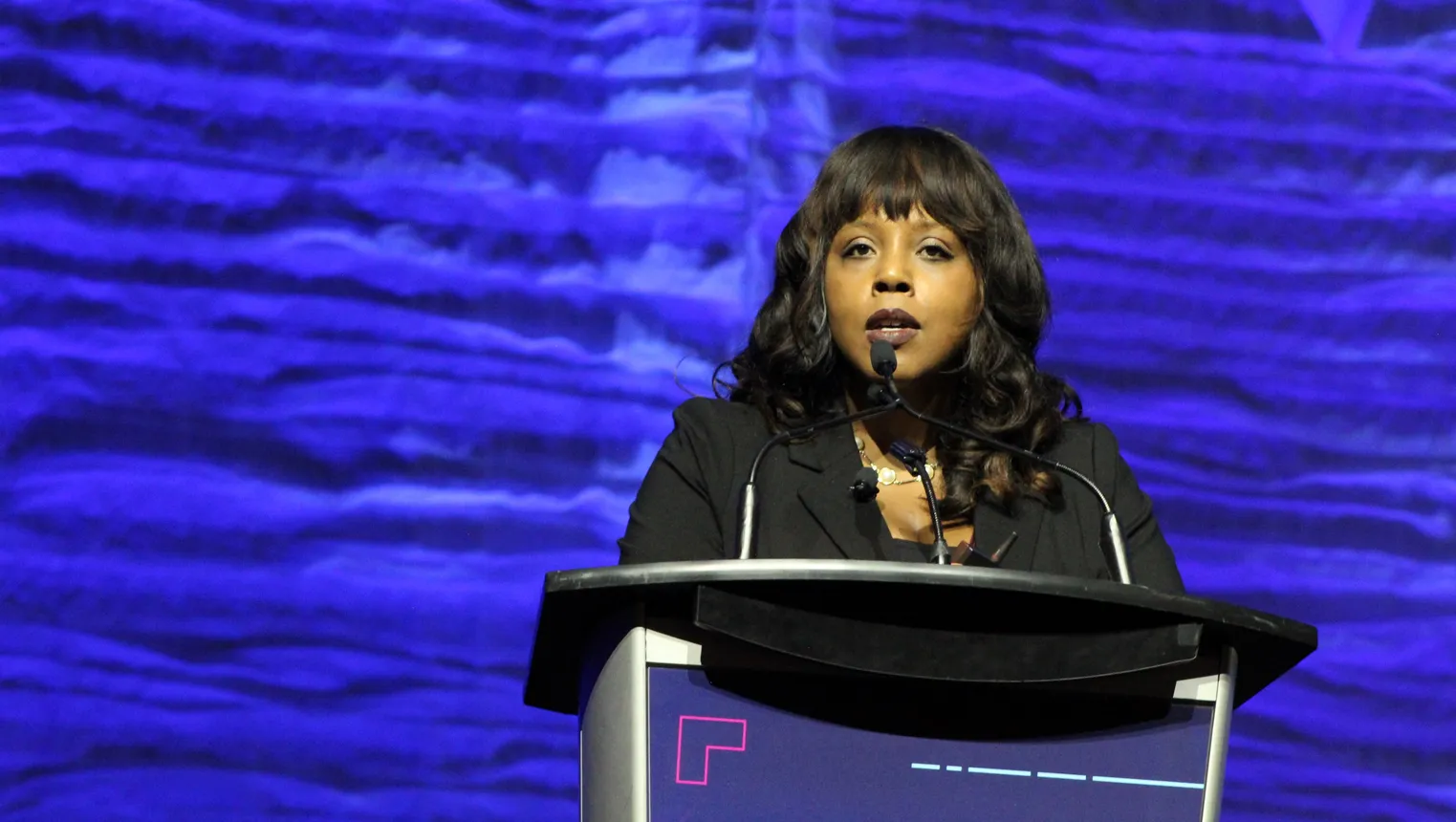 A person speaks at a podium.