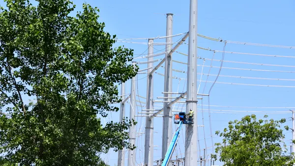 A worker on a transmission tower.