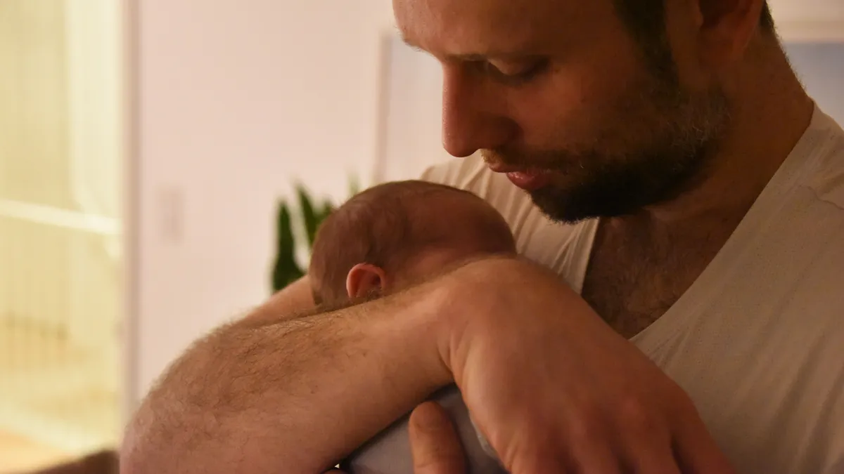 Teacher John McCrann with newborn son